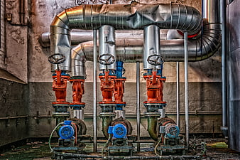 Abandoned Industrial Boiler Room With Rusty Pumps And Metal Pipes