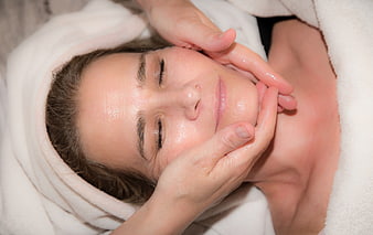 Woman Receiving Facial Massage Treatment With Oil