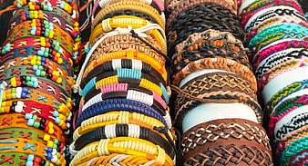Colorful handmade leather and beaded bracelets on display