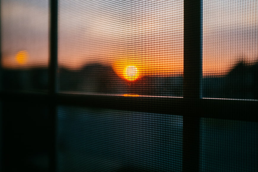Sunset View Through Window Screen Mesh