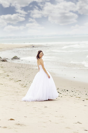 Bride in White Wedding Dress on Sandy Beach