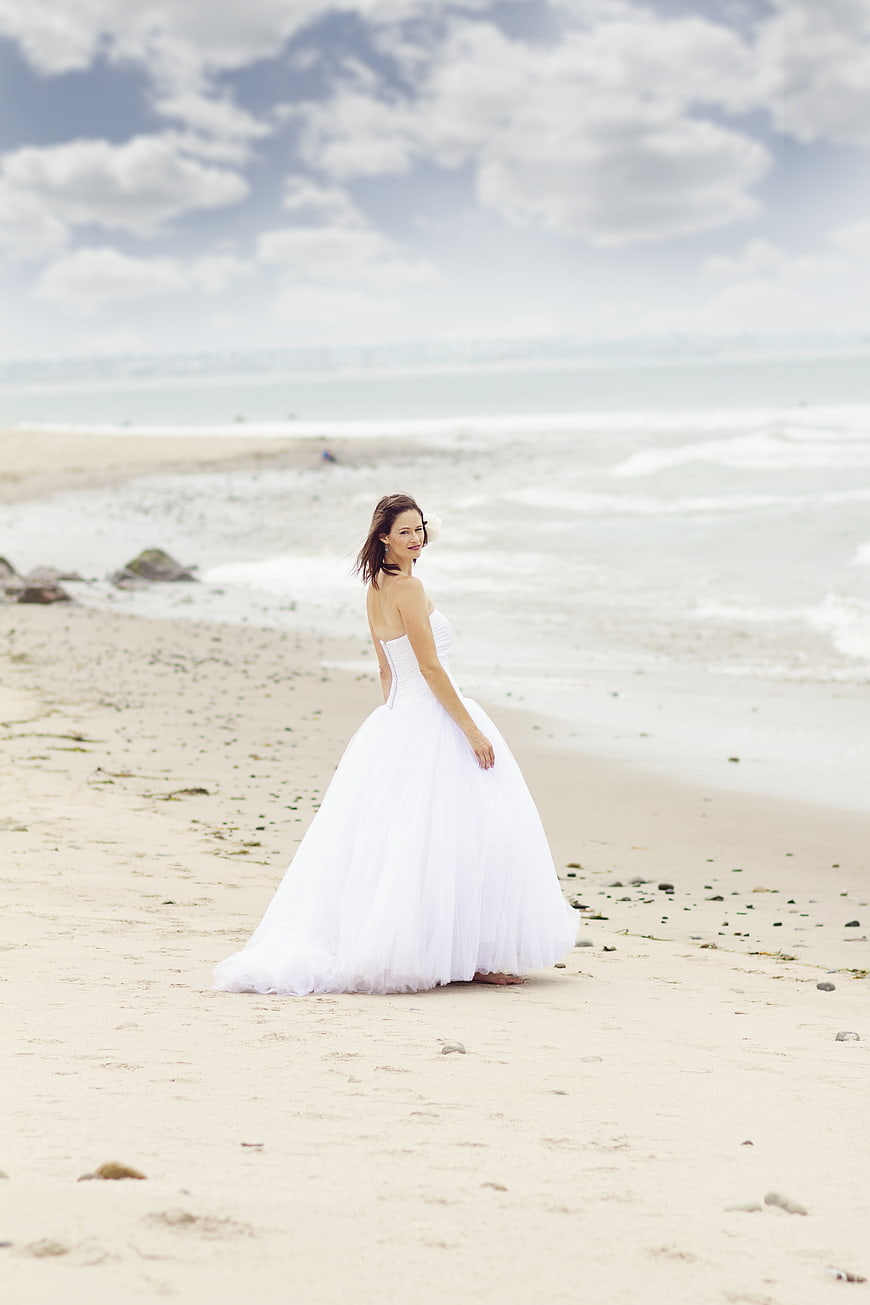 Bride in White Wedding Dress on Sandy Beach