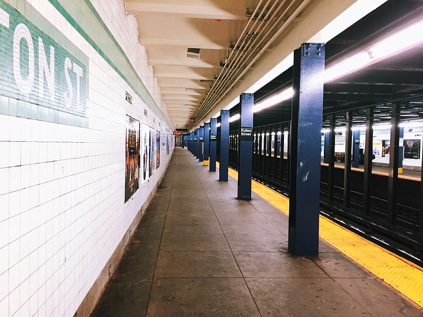 Empty Fulton Street Subway Station Platform with Blue Pillars