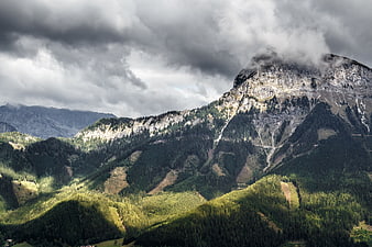Dramatic Mountain Landscape with Clouds and Forested Valleys