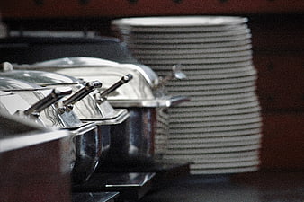 Stainless Steel Buffet Chafing Dishes And Stacked Plates