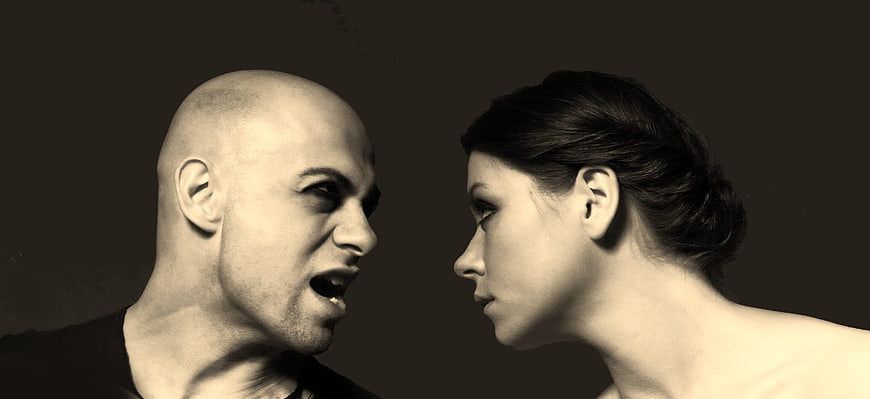 Angry man shouting at woman in sepia portrait