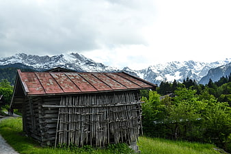 Rustic wooden cabin with mountain backdrop