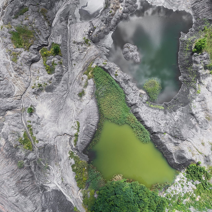 Aerial view of green lakes in rocky quarry landscape