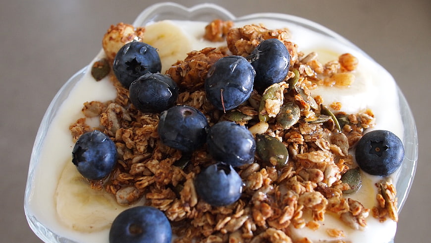Healthy yogurt parfait with granola, blueberries, and banana