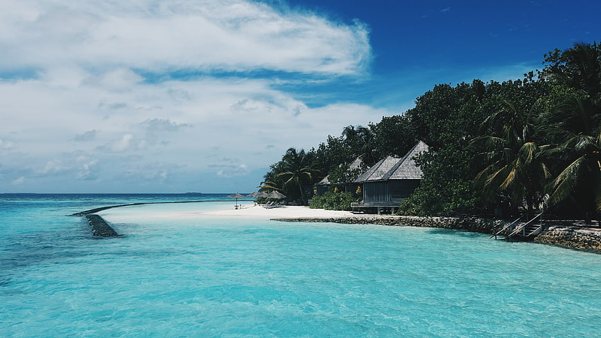 Tropical Beach Resort with Turquoise Lagoon and Overwater Bungalows