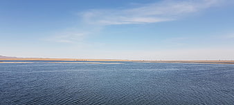 Panoramic View of Calm Blue Lake in Arid Desert Landscape