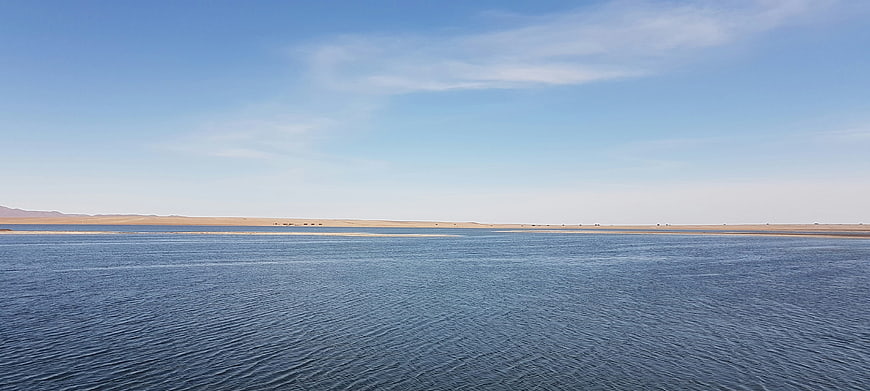 Panoramic View of Calm Blue Lake in Arid Desert Landscape