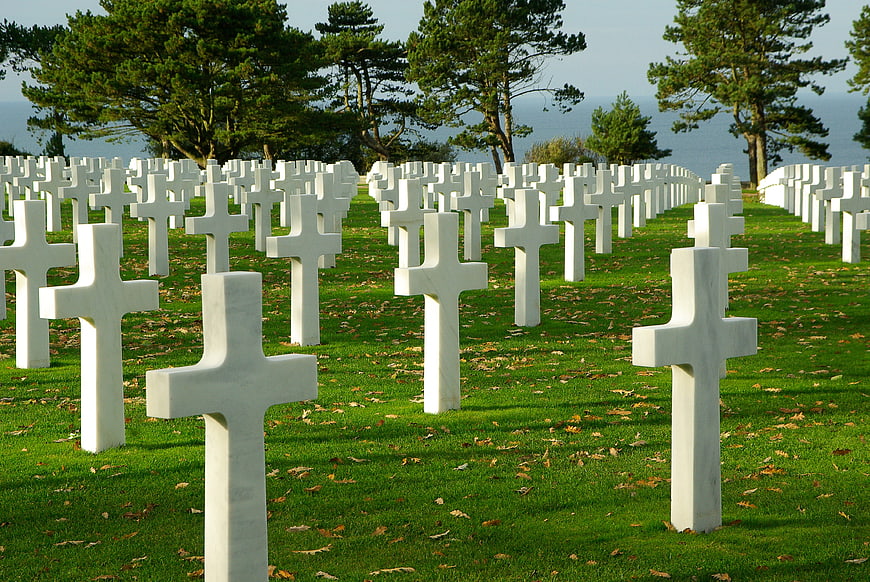 Rows of white crosses in a coastal military cemetery