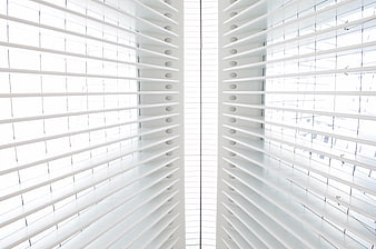 Symmetrical white window blinds with bright natural light