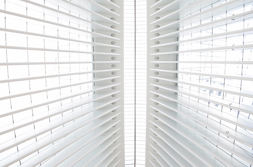 Symmetrical white window blinds with bright natural light