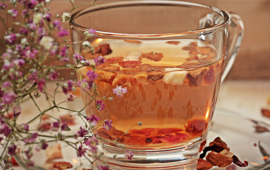 Glass Cup of Herbal Tea with Dried Flowers and Fruits