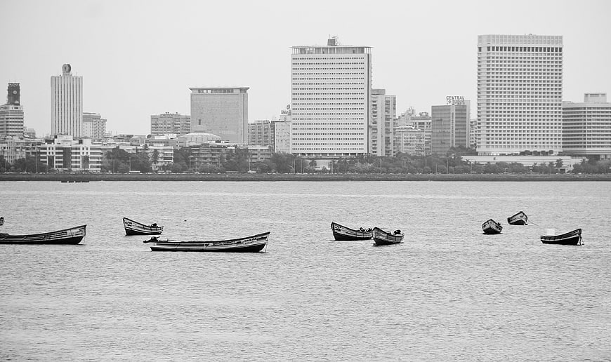 Black and white cityscape with boats on the water