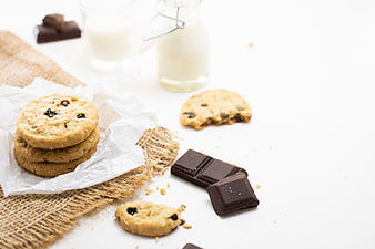 Chocolate chip cookies with milk and dark chocolate on white background