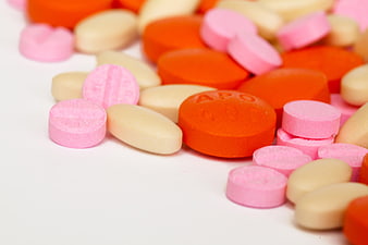 Colorful Assorted Pills and Tablets on White Background