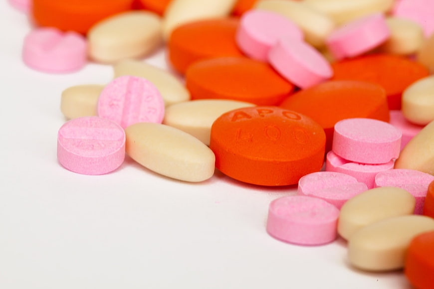 Colorful Assorted Pills and Tablets on White Background