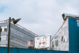Urban Street Art with Stay Human Mural on Blue Wall