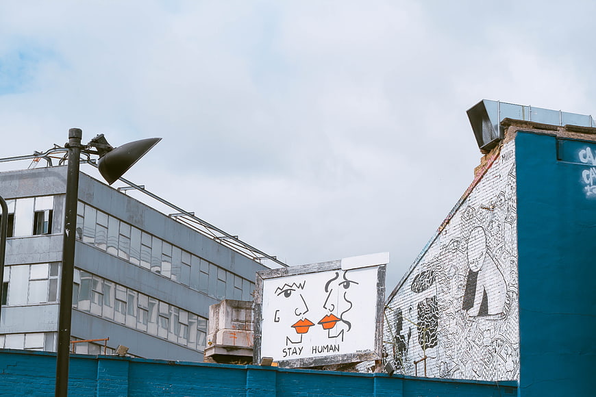 Urban Street Art with Stay Human Mural on Blue Wall