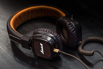 Black Over-Ear Headphones With Brown Leather Headband On Dark Surface