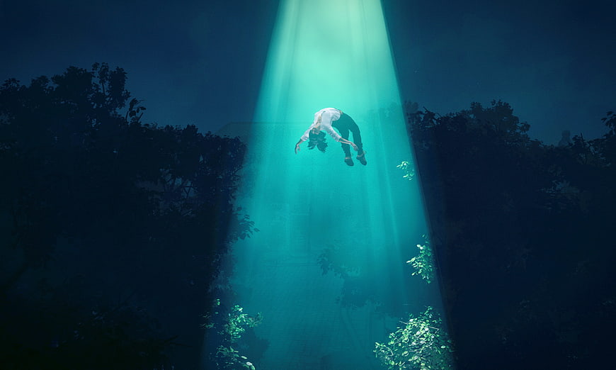 Woman floating in underwater beam of light