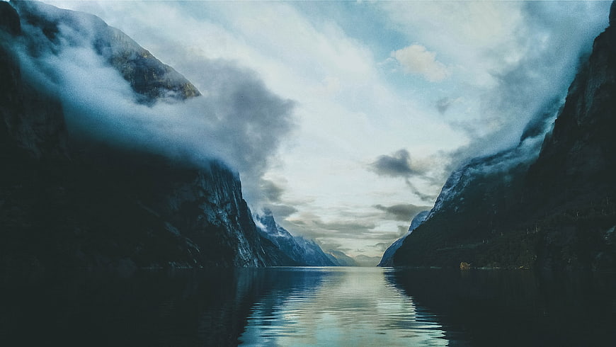 Misty Fjord Landscape with Calm Water and Mountains