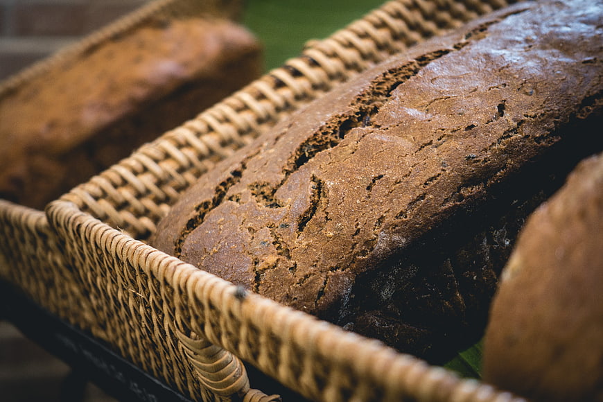 Rustic wholewheat bread loaf in woven basket