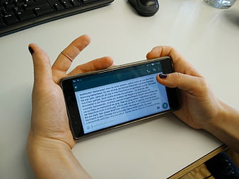 Hands holding smartphone displaying scary German chain letter text