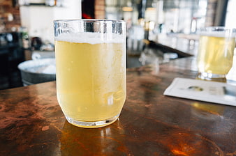 Cold Craft Beer in Glass on Rustic Bar Counter