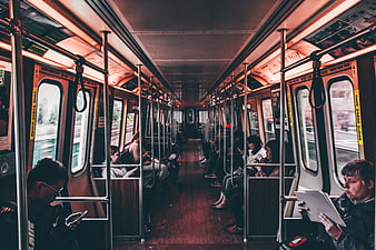 Passengers commuting inside a subway train car