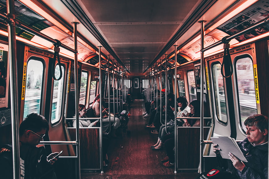 Passengers commuting inside a subway train car