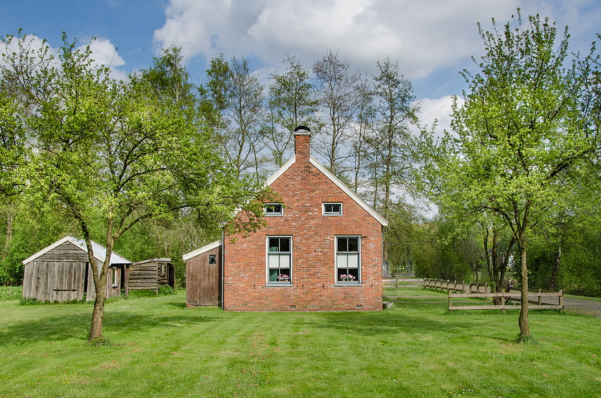 Traditional Dutch Brick House in Green Landscape