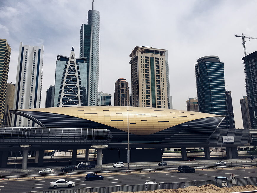 Modern Dubai Metro Station with Skyscrapers and Highway Traffic
