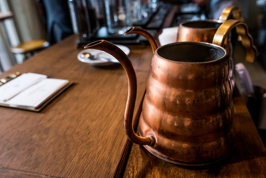 Vintage Copper Gooseneck Kettle on Wooden Table