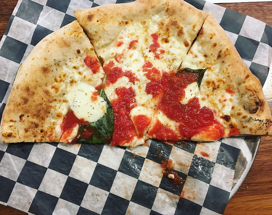 Fresh Margherita Pizza Slices on Checkered Paper