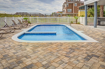 Private swimming pool with paver patio and lounge chairs