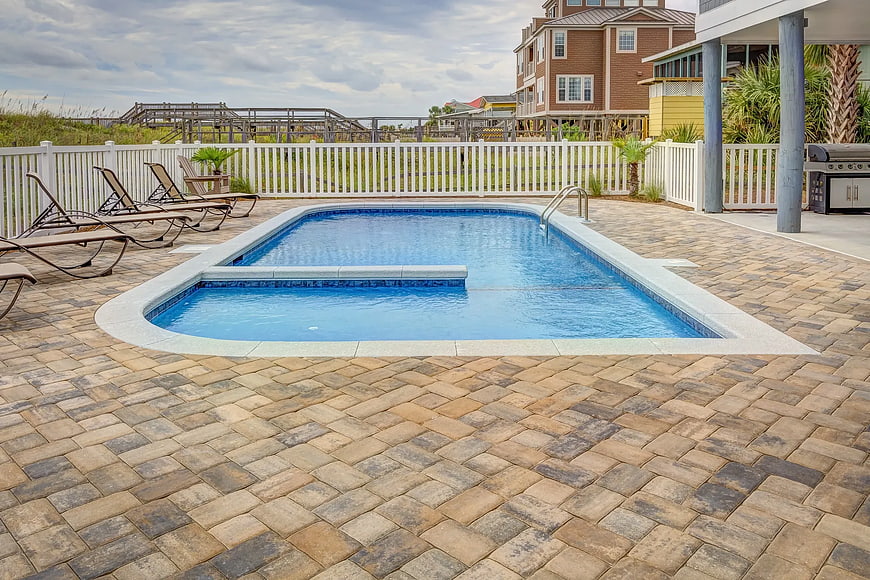 Private swimming pool with paver patio and lounge chairs