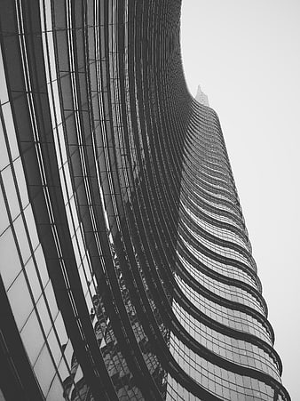 Black and white low angle view of twisting skyscraper facade