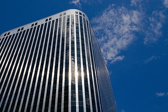 Modern Glass Skyscraper Against Blue Sky