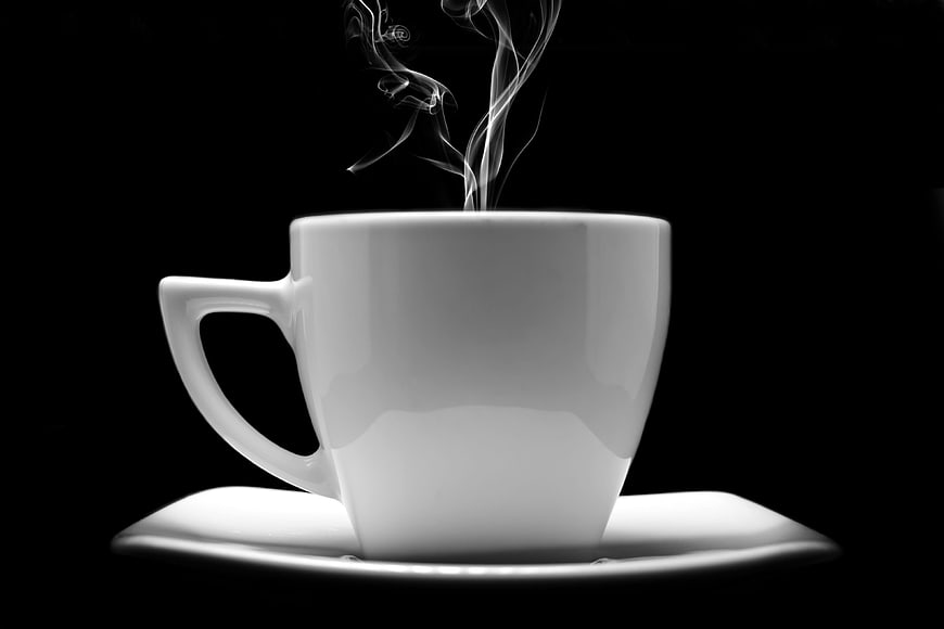 Steaming White Coffee Cup on Black Background