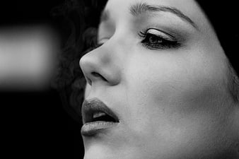 Black and white close-up portrait of a woman with smoke