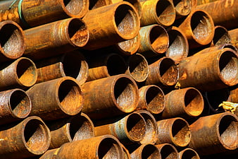Stack of Rusted Metal Pipes with Textured Corrosion