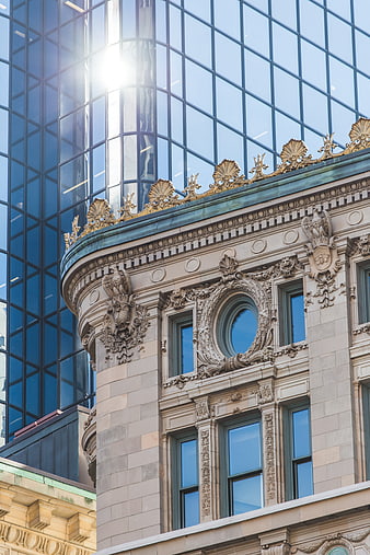 Ornate historic building facade with modern glass skyscraper background