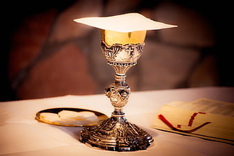Silver Chalice with Paten and Bible on Altar