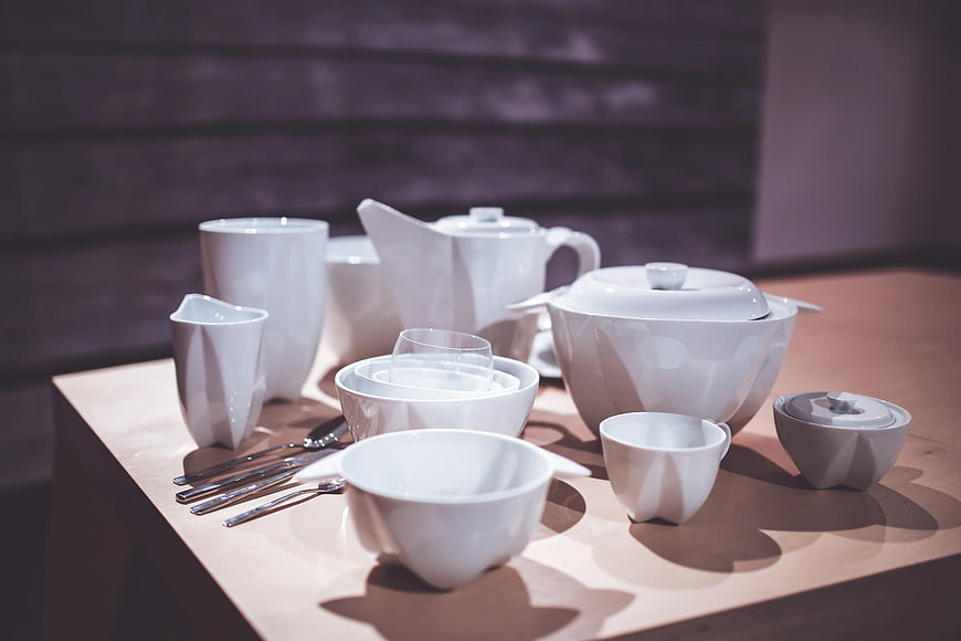 Modern white ceramic tableware set on wooden table