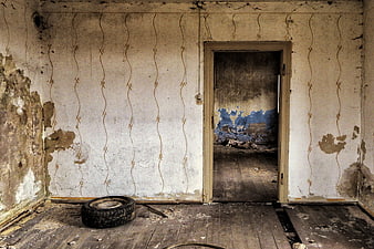 Abandoned Room with Peeling Wallpaper and Old Tire