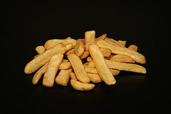 Golden French Fries Piled on Black Background